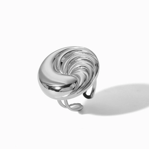 Detailed view of an adjustable silver spiral ring with polished finish and open-ended band