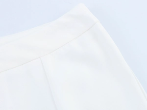 Detail shot of a white trouser waistline showing high-quality stitching and fabric texture