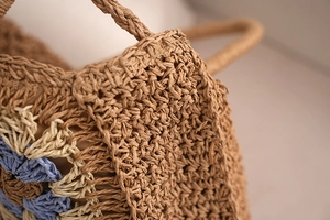 Macro detail of hand-woven crochet straw bag showing multi-color stitch patterns