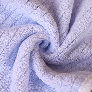 Macro shot of soft light blue coral fleece fabric texture showing high water absorption