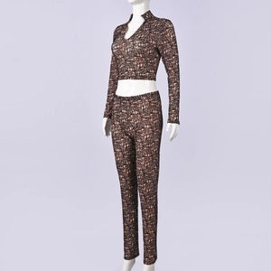 Detail of slim-fit two-piece set featuring geometric mesh print on crop top and leggings