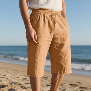 Detail of khaki linen shorts with drawstring waist for men in a beach holiday setting