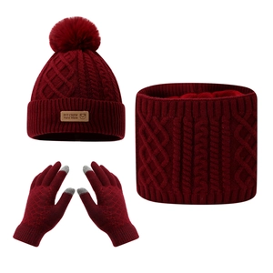 Macro detail of burgundy knit set featuring bear leather patch and plush lining texture