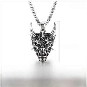 Detail of a punk style stainless steel demon mask pendant showing 43x26mm product dimensions