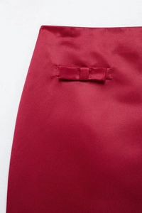 Close-up of the elegant red satin bow detail on the Christmas two-piece set skirt