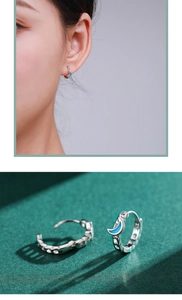 Detail of silver moon-shaped enamel hoop earrings with model display and close-up view