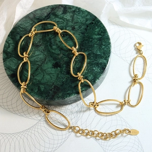 Vintage 18k gold plated geometric chain necklace on a green marble plate display