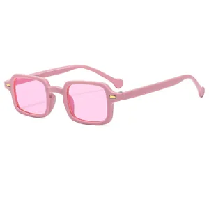Retro small square frame sunglasses in pink with transparent lenses and gold accents
