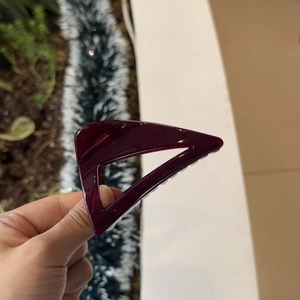 Deep wine red hollow triangular hair claw clip with a glossy finish for elegant styling