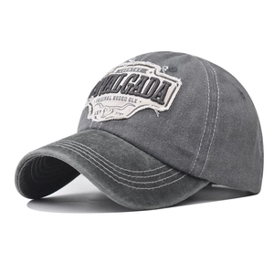 Close-up of distressed grey cotton baseball cap with vintage rodeo patch embroidery