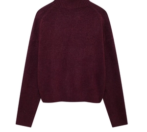 Detail of burgundy turtleneck sweater featuring ribbed cuffs and hem on white background
