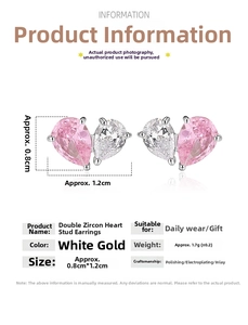 Detail of pink and clear heart shaped zircon earrings in polished silver finish