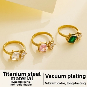 Detailed macro view of three gold-plated titanium steel rings with colorful zircon stones