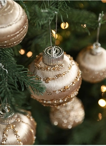 Detail of champagne Christmas ornament with silk threads, gold sequins and beads
