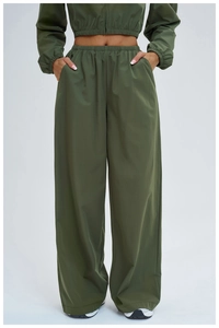 Detail of dark green moisture-wicking joggers featuring side pockets and high waist design