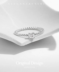 Detailed view of silver beaded ring featuring a square-cut clear moissanite stone