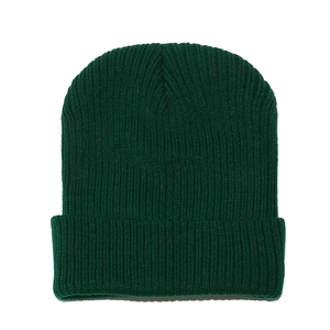 Close-up of deep green ribbed knit beanie showing high-quality textured warm fabric