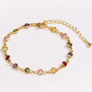 Close-up of gold chain bracelet with colorful round zircons and secure lobster clasp