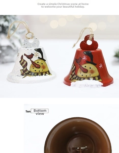 Detail of red and white metal Christmas bells with hand-painted snowmen and jute ropes