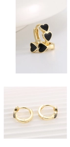 Detailed macro view of S925 sterling silver gold earrings with black enamel heart charms