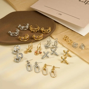 Collection of geometric stainless steel earrings with gold and silver crystal accents