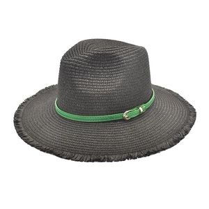 Detail of black straw fedora hat featuring green leather band and frayed brim edge