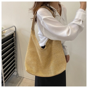 Detail of beige woven straw tote bag featuring hollow mesh texture and large capacity