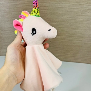 Detailed close-up of pink plush unicorn baby security blanket with rainbow horn