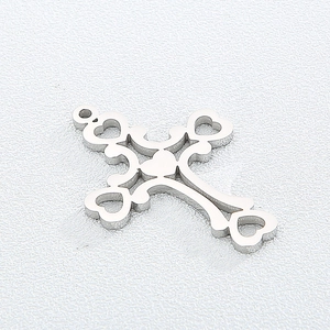 Polished silver cross pendant with hollow heart cutout design on white textured background