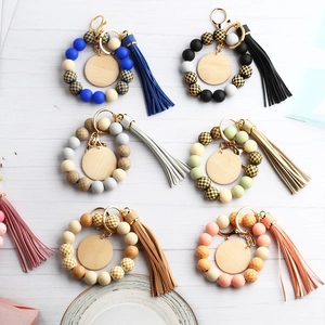 Silicone beaded wristlet keychain with checkered patterns, wood discs and long tassels