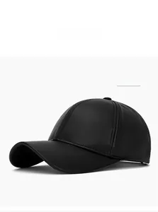 Detail shot of black PU leather baseball cap with fine lychee texture and stitching