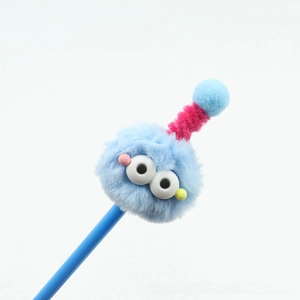 Close-up of blue fuzzy monster plush pen with large eyes and pink spiral antenna