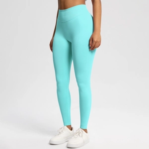 Detail of high-waisted seamless yoga leggings in turquoise with peach lift effect