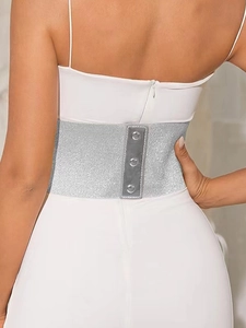 Detail of silver glitter wide elastic belt with three snap buttons on white dress