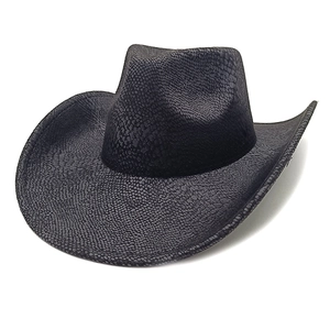 Macro detail of black western cowboy hat featuring unique faux snakeskin scale texture