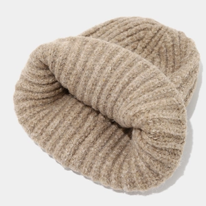 Detail of oatmeal ribbed knit beanie showing thick woolen texture and folded cuff style