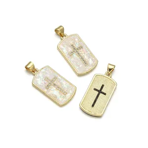 Gold plated cross pendant with zircon inlay and opal style base on white background