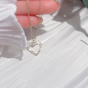 Elegant gold titanium necklace with a heart-shaped cubic zirconia pendant on silk