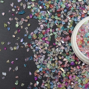 Close-up of colorful iridescent irregular glass shards for nail art and DIY jewelry crafts