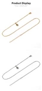 Vue détaillée de colliers gouttes d'eau or et argent avec cristaux verts et zircons