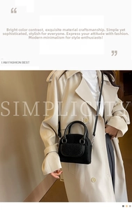 Detail of black faux fur and leather contrast handbag on beige trench coat model