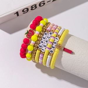Detail of colorful beaded bracelets with teacher-themed charms like apples and pencils