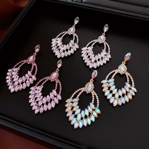 Macro view of multi-color teardrop dangle earrings with marquise-cut crystal clusters