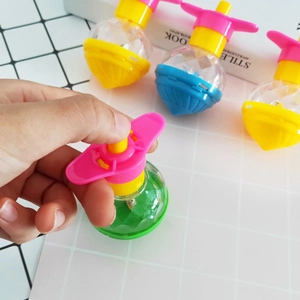 Close-up of colorful plastic spinning top toys being demonstrated by hand for kids