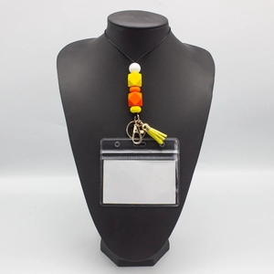 Detail of colorful silicone bead lanyard with yellow tassel on a professional neck bust