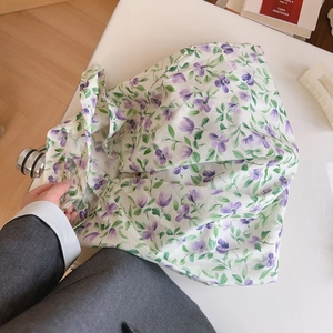 Close-up of lightweight purple floral cotton tote bag with natural fabric texture