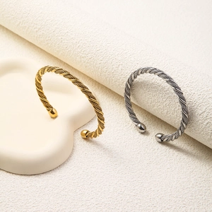 Close-up of 5.5mm woven wire twisted mesh open bangle with smooth bead end caps