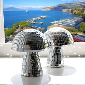 Macro shot of silver mirrored mushroom disco balls showing reflective glass tiles and light spots