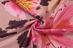 Detailed close-up of floral lily and leopard print on soft twill weave summer dress fabric