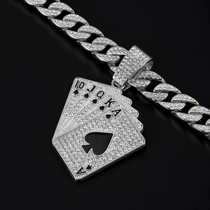 Macro shot of silver Cuban chain with diamond-encrusted poker card flush pendant